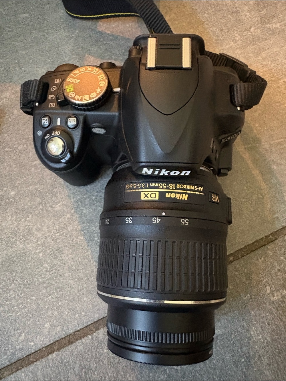Nikon Black DSLR Camera with Black Lens and Gold Accents